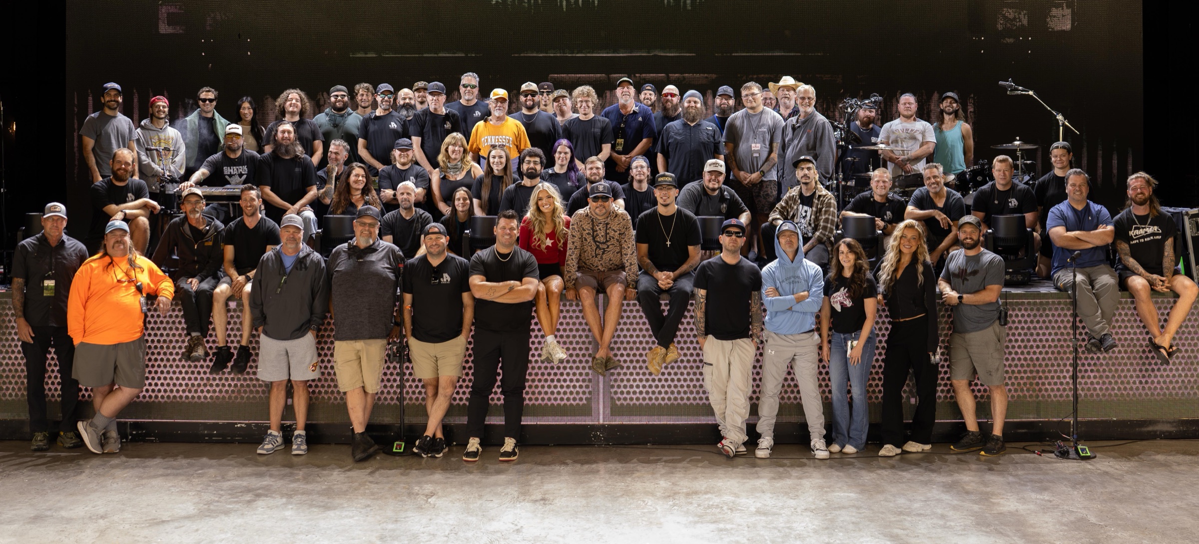 Full touring crew group photo on the front of the stage